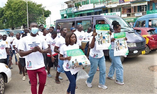 Some participants displaying flyers and posters during the awareness on the COVID-19 vaccination sensitisation walk. Picture: ELVIS NII NOI DOWUONA